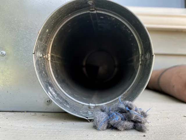 University Heights Dryer Vent Cleaning technician using specialized equipment to clear severe dryer vent blockage in University Heights